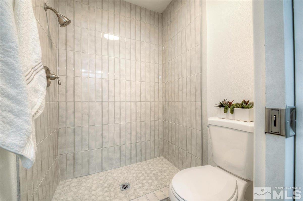 2014 Branch Reno, NV 89509 - Photo 23 of 40 a white toilet sitting next to a shower curtain
