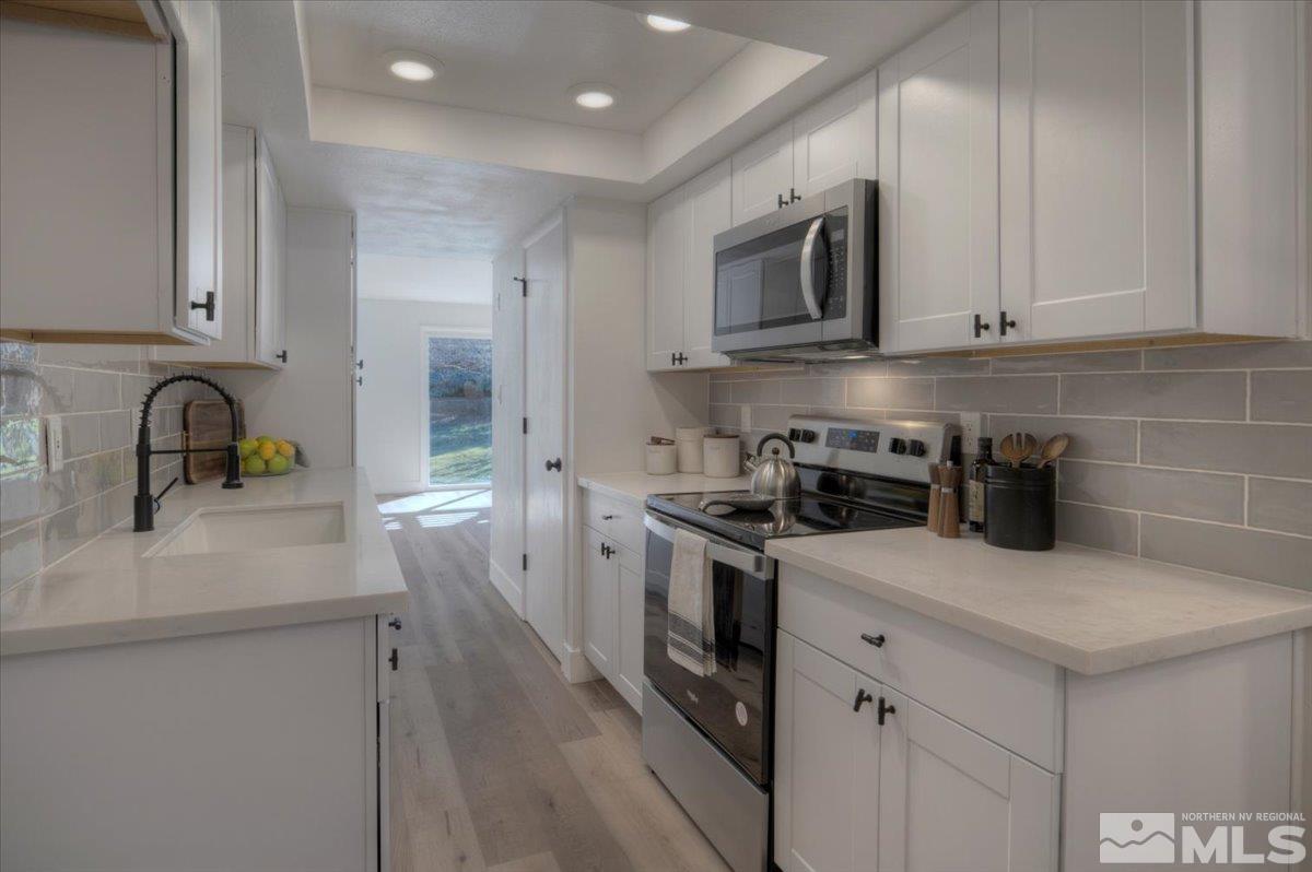 2014 Branch Reno, NV 89509 - Photo 3 of 40 a kitchen with a sink stove and microwave