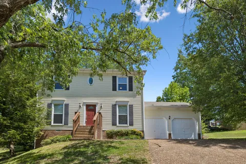 front view of a house with a tree