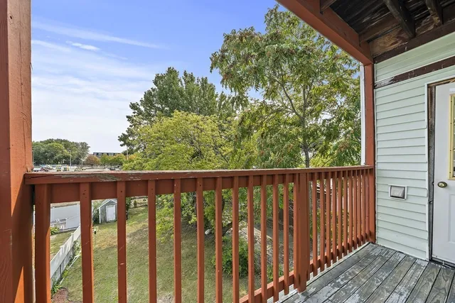 a balcony with wooden floor and outdoor space