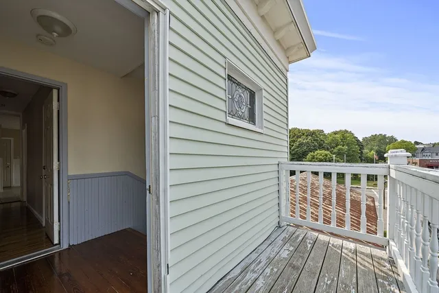 a view of a balcony with wooden floor