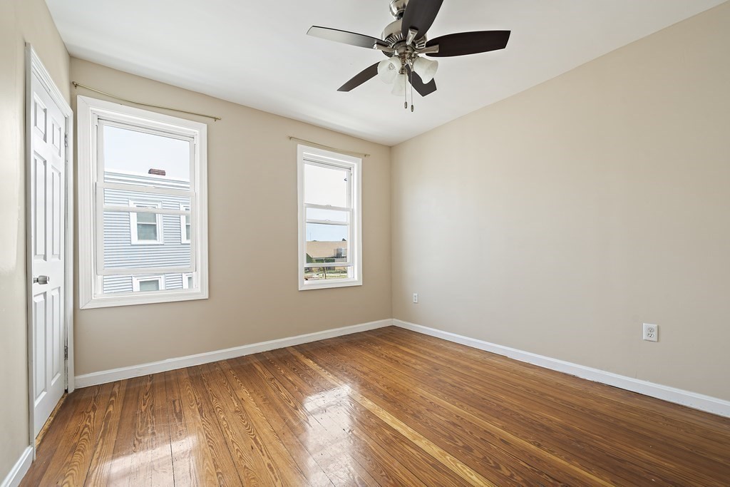 7 Tolman Street, Unit 3 Boston, MA 02122 - Photo 4 of 12 wooden floor in an empty room with a window