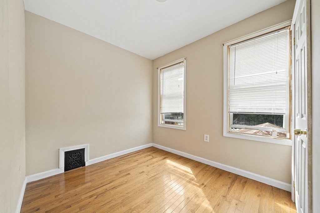 7 Tolman Street, Unit 3 Boston, MA 02122 - Photo 6 of 12 a view of an empty room with wooden floor and a window