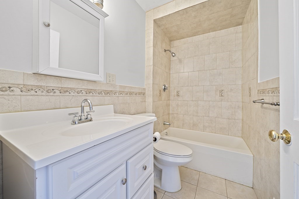 7 Tolman Street, Unit 3 Boston, MA 02122 - Photo 7 of 12 a bathroom with a sink a toilet and shower