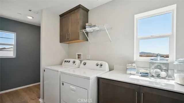 a utility room with sink dryer and washer