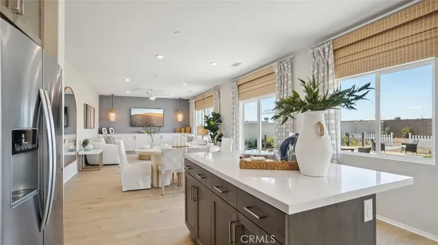 a view of kitchen with living room and refrigerator