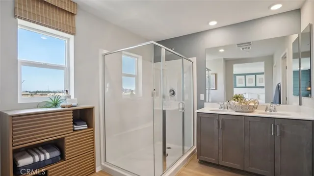 a bathroom with a double vanity sink and a mirror