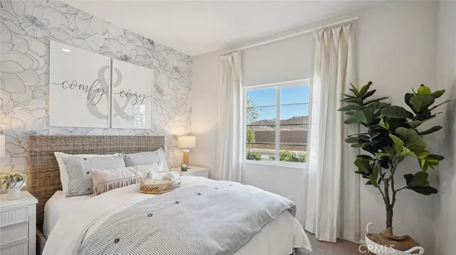 a bedroom with a bed and a potted plant