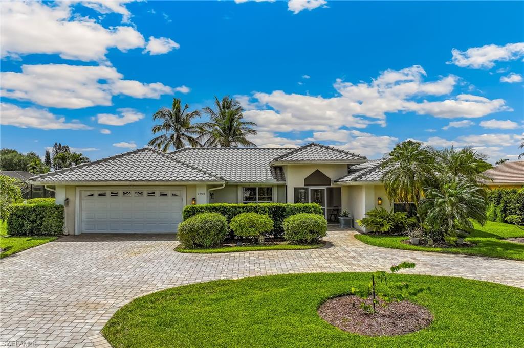 1904 Countess Court Naples, FL 34110 - Photo 2 of 33 a front view of a house with a yard