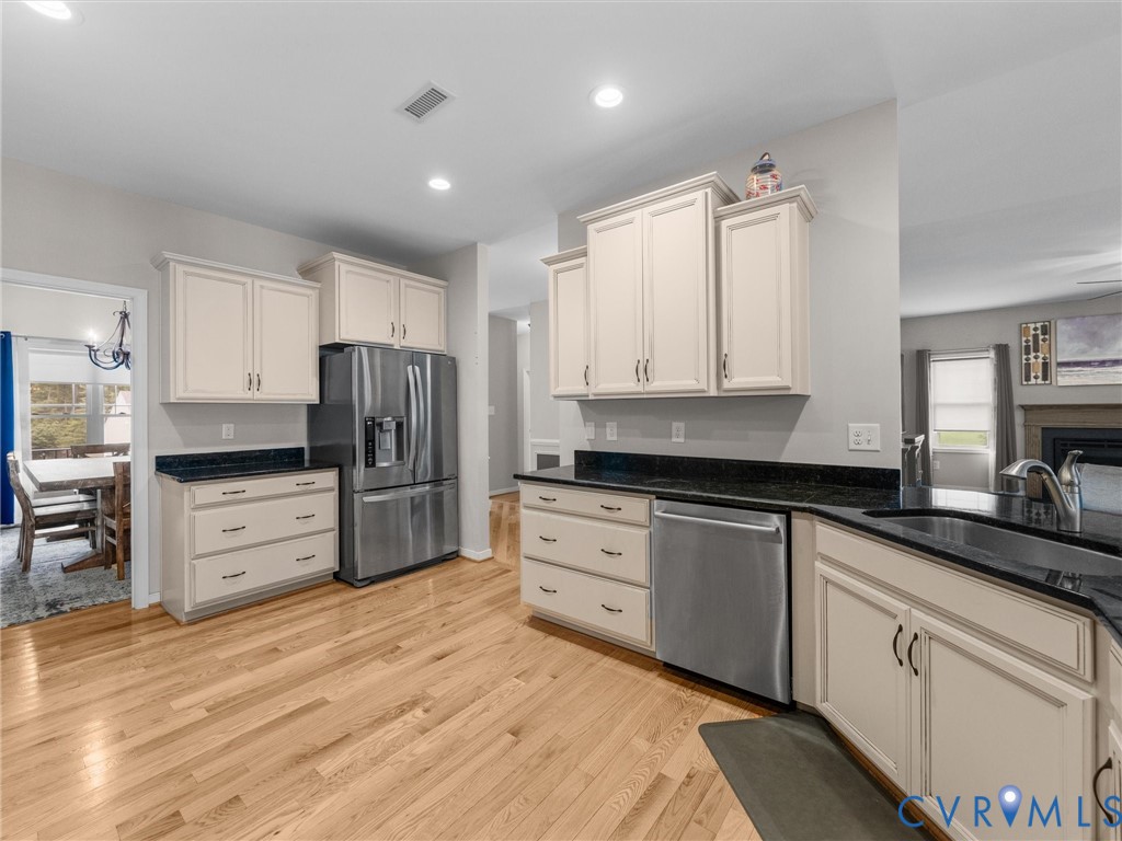 10824 Avening Road Chesterfield, VA 23832 - Photo 12 of 47 a kitchen with granite countertop white cabinets and stainless steel appliances