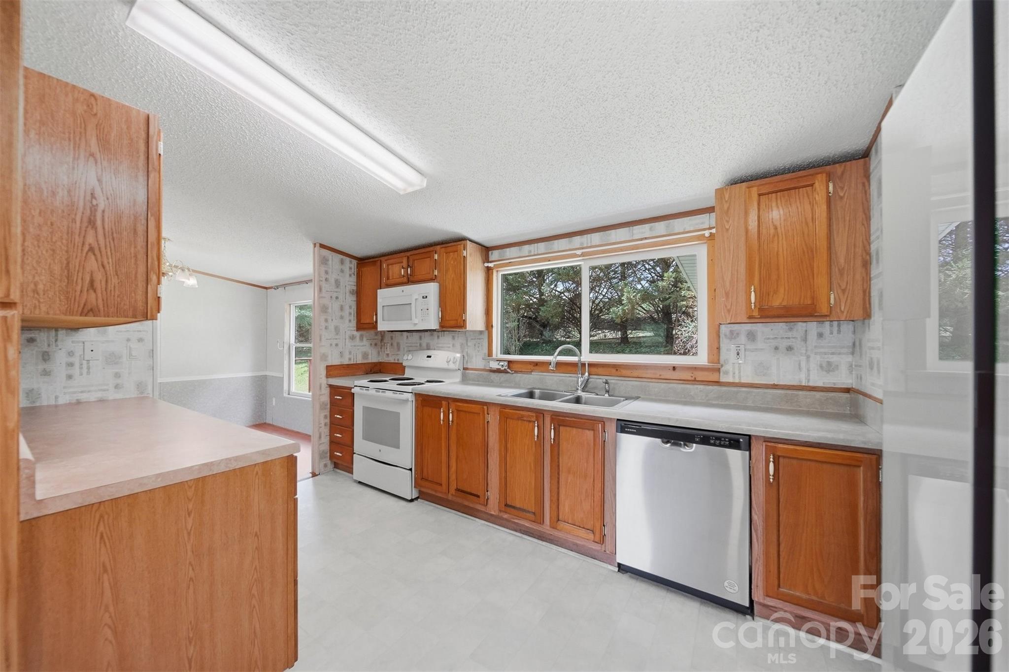 1488 Watermill Road Morganton, NC 28655 - Photo 12 of 38 a kitchen with stainless steel appliances granite countertop wooden cabinets a sink and a stove