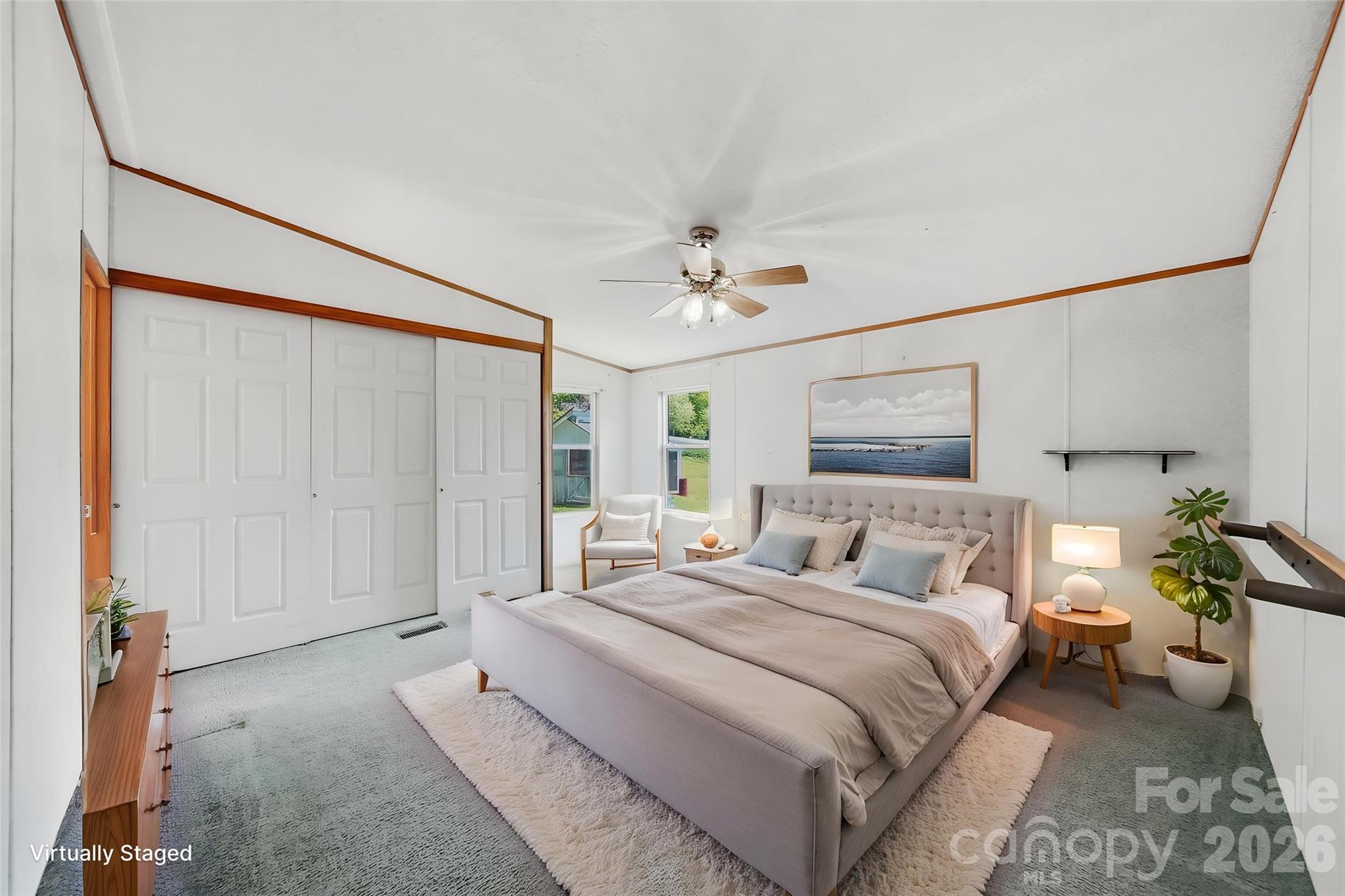 1488 Watermill Road Morganton, NC 28655 - Photo 16 of 38 a bedroom with a large bed and a chandelier