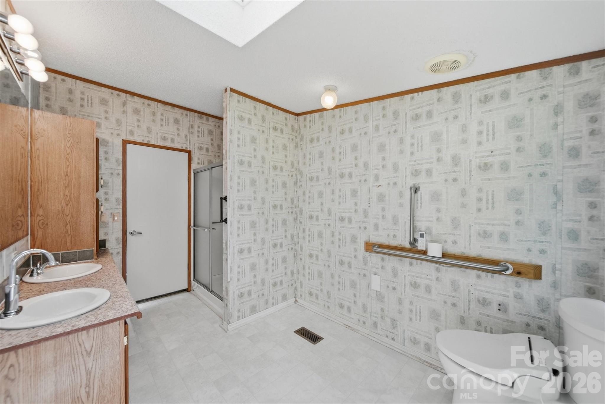 1488 Watermill Road Morganton, NC 28655 - Photo 18 of 38 a bathroom with a sink a toilet and shower