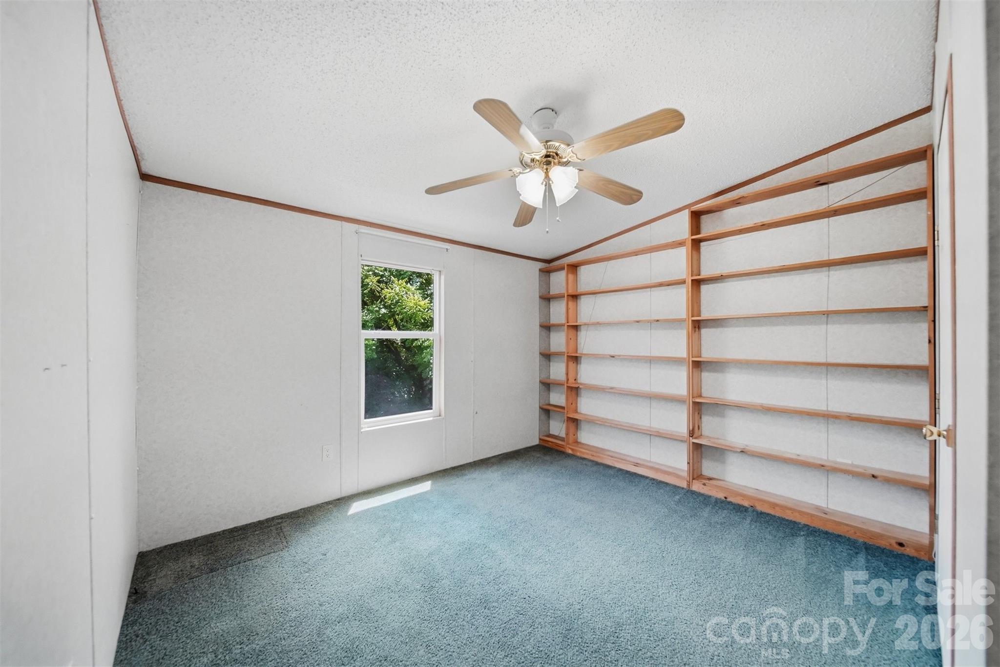 1488 Watermill Road Morganton, NC 28655 - Photo 19 of 38 a view of a room with a ceiling fan and hardwood floor