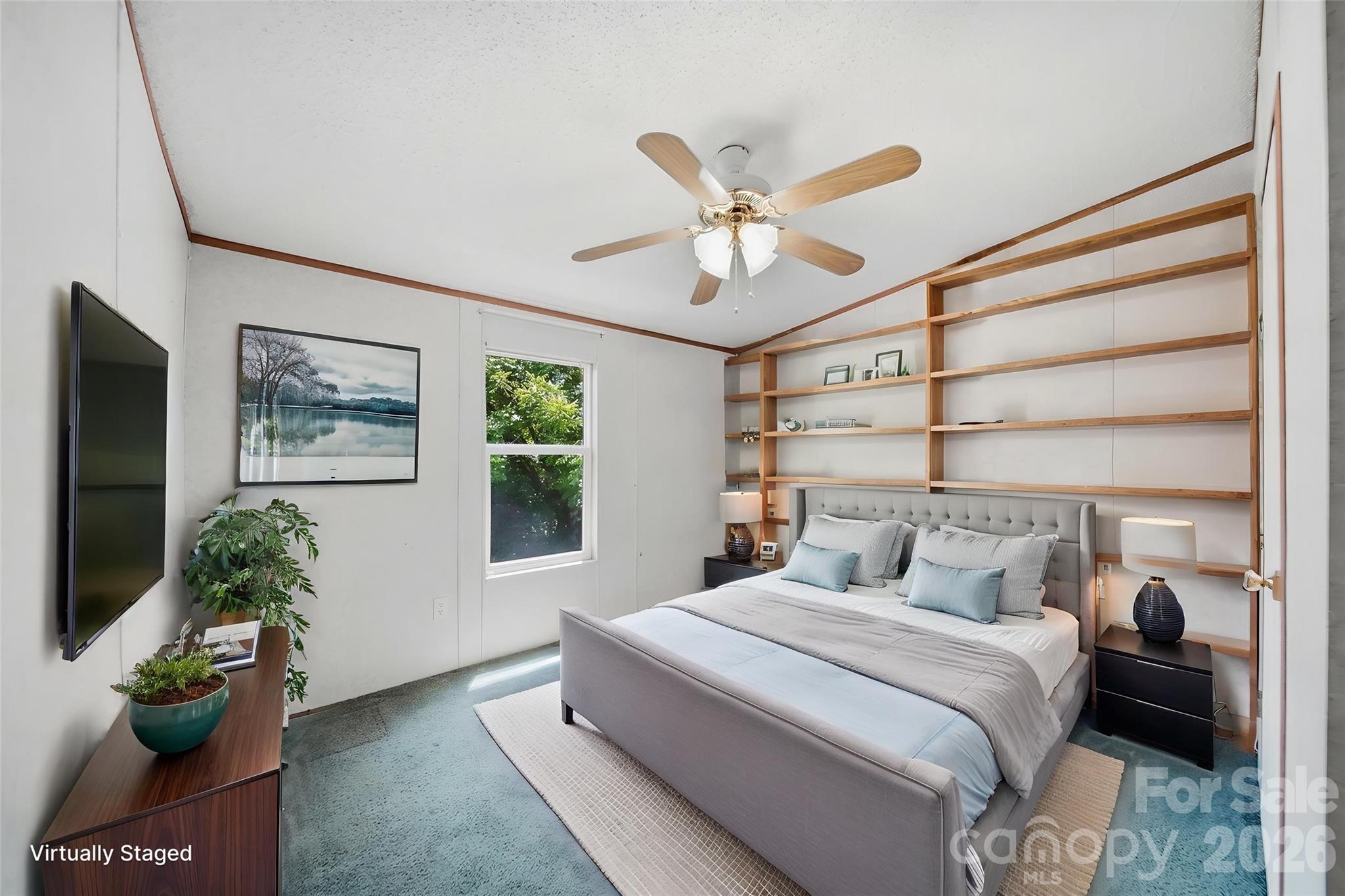 1488 Watermill Road Morganton, NC 28655 - Photo 20 of 38 a bedroom with a large bed and a chandelier