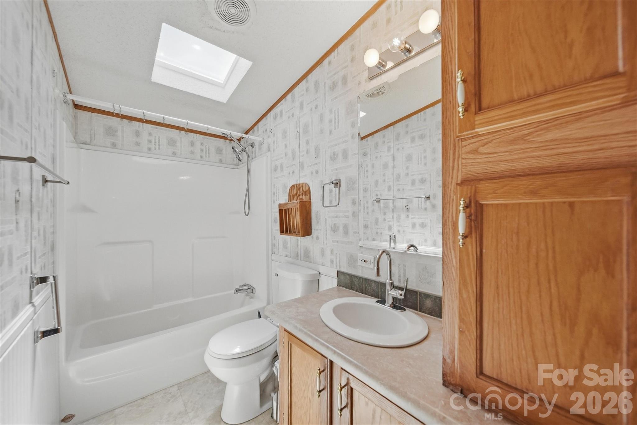 1488 Watermill Road Morganton, NC 28655 - Photo 21 of 38 a bathroom with a sink a toilet and shower