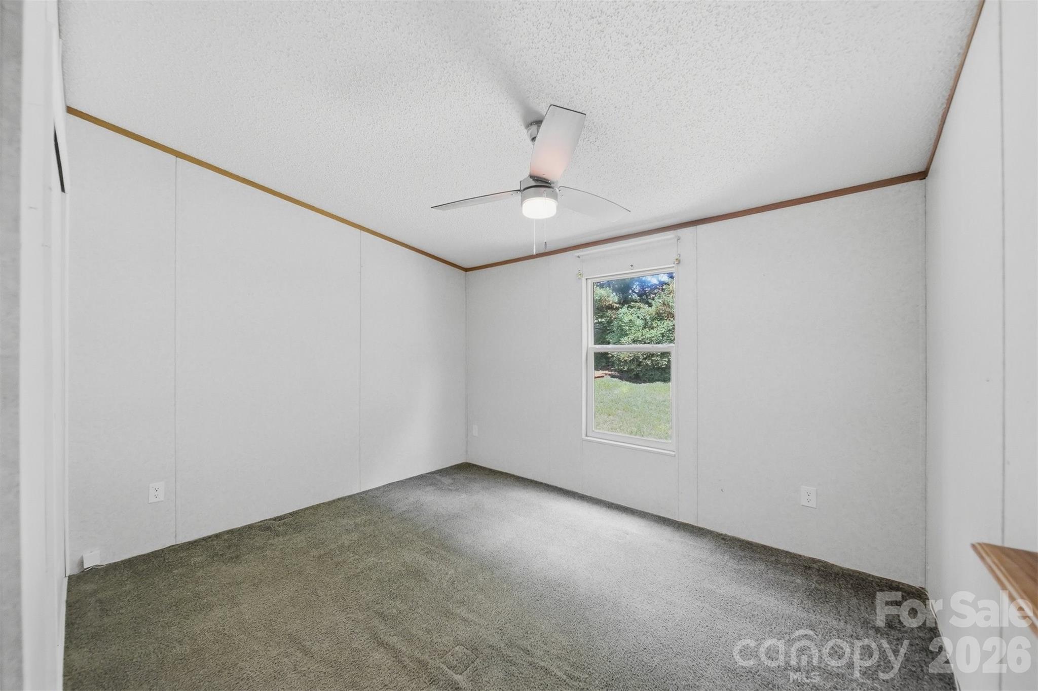 1488 Watermill Road Morganton, NC 28655 - Photo 22 of 38 an empty room with windows and ceiling fan