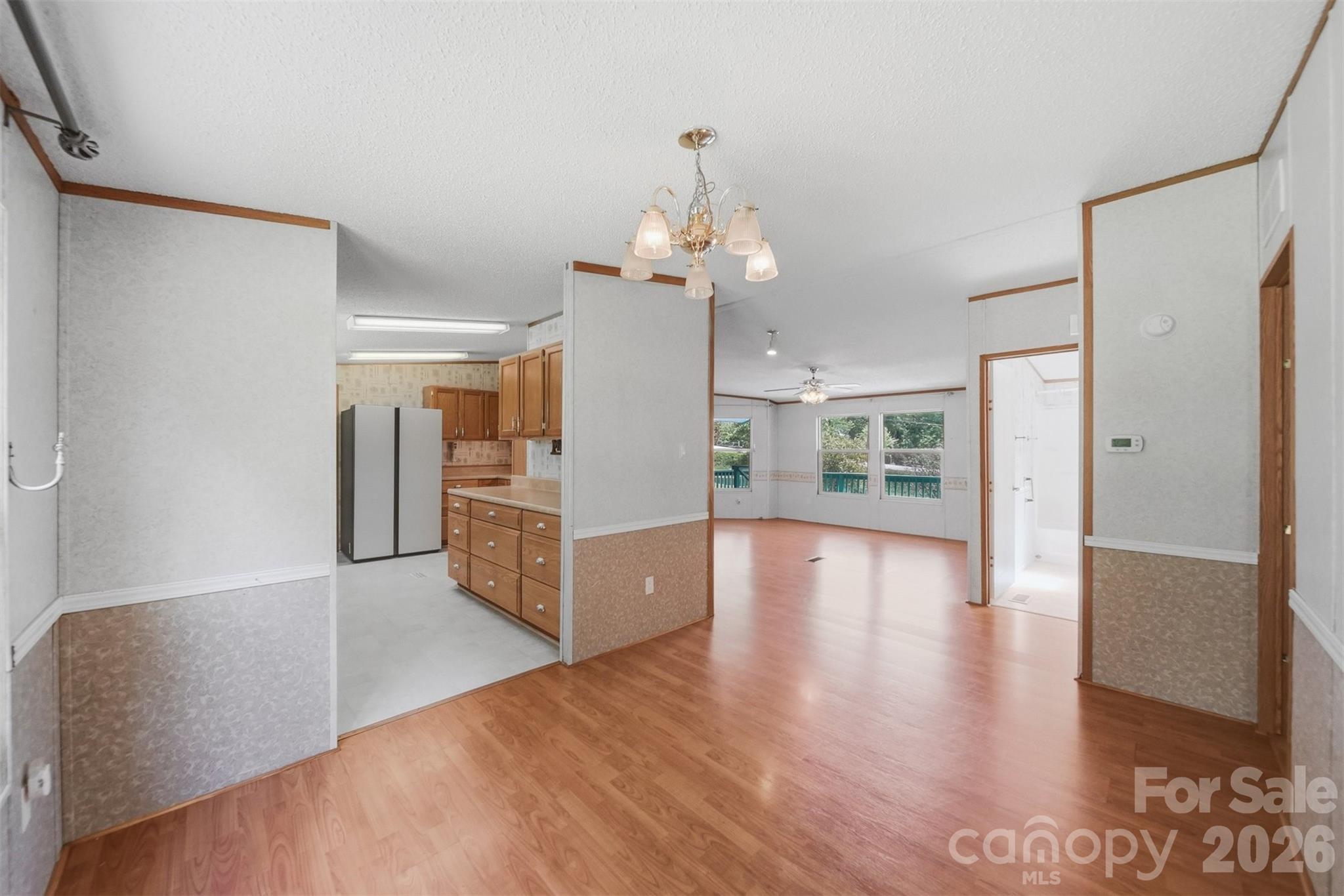 1488 Watermill Road Morganton, NC 28655 - Photo 8 of 38 a view of a hallway with wooden floor and a kitchen