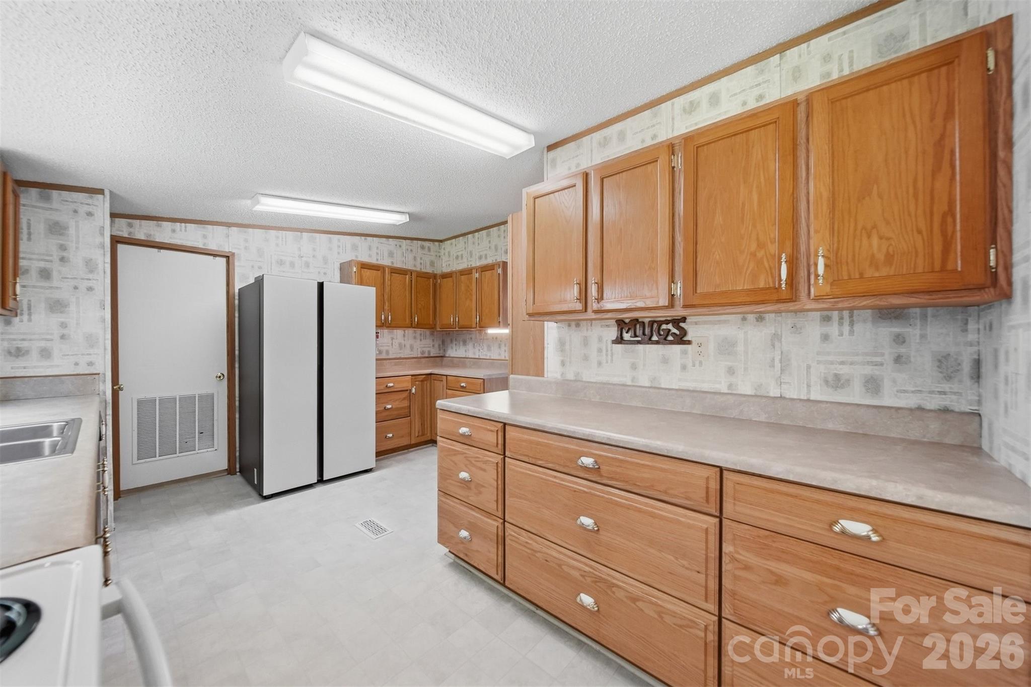 1488 Watermill Road Morganton, NC 28655 - Photo 10 of 38 a kitchen with stainless steel appliances granite countertop a refrigerator and cabinets