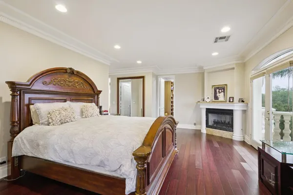 a bedroom with a large bed and a fireplace
