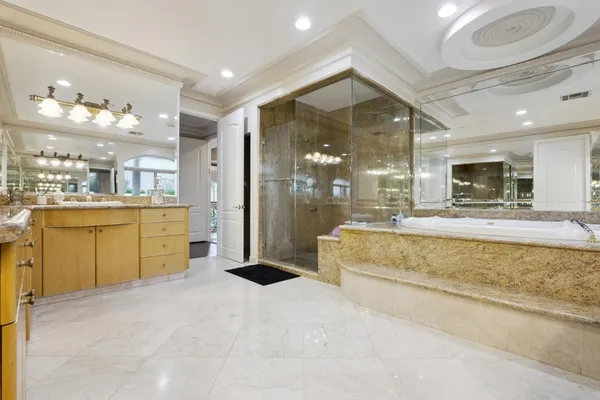 a large spacious bathroom with a large tub and sink