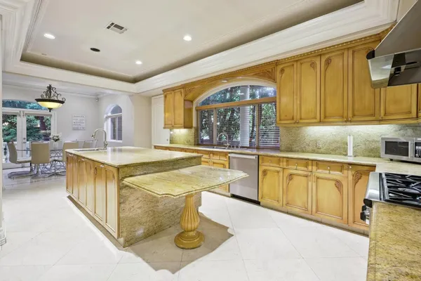 a kitchen with stainless steel appliances kitchen island granite countertop a sink and cabinets