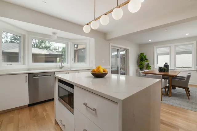 a kitchen with a sink and living room