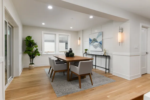 a view of a dining room with furniture and wooden floor