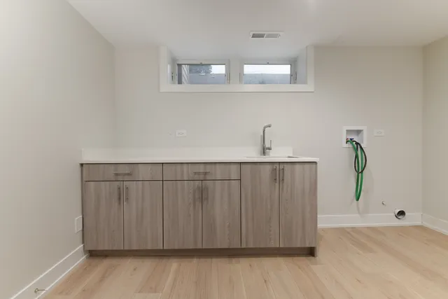 a view of a room with wooden floor and hallway