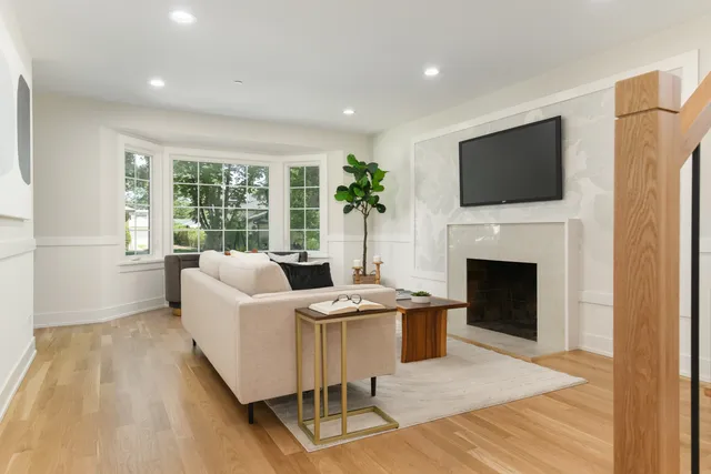 a living room with furniture a fireplace and a flat screen tv