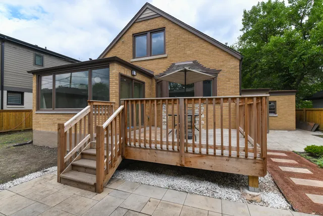a view of a house with a wooden deck