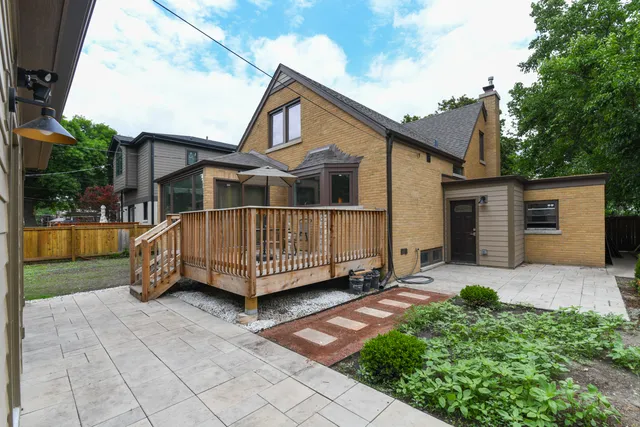 a view of a house with a yard and sitting area