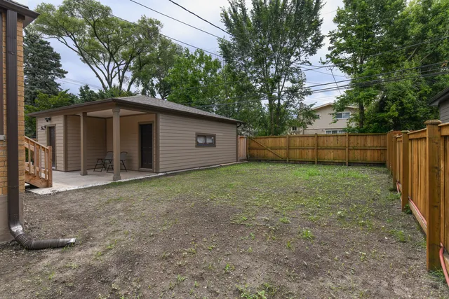 a view of a backyard with a large tree