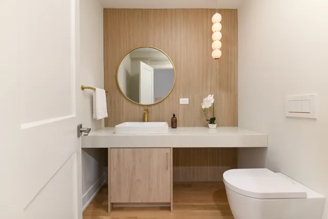 a bathroom with a sink a toilet and a mirror