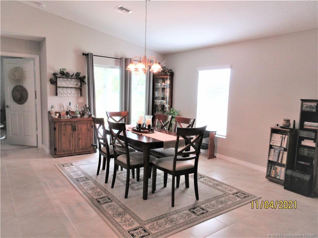 693 Southwest Jada Road Port St. Lucie, FL 34953 - Photo 4 of 18 KITCHEN OPEN TO DINING ROOM LEADING TO PATIO