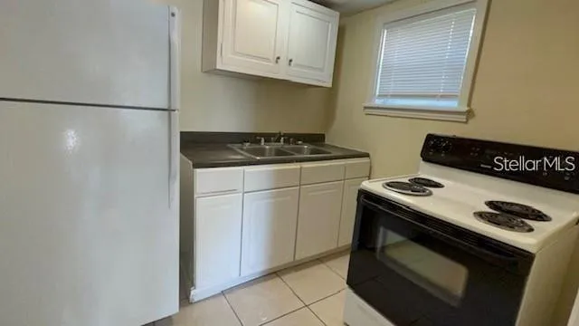 a stove top oven sitting inside of a kitchen