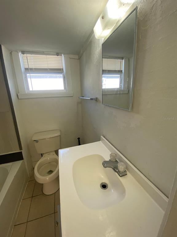 930 18th Street, Unit B Orlando, FL 32805 - Photo 9 of 11 a bathroom with a sink and mirror with toilet