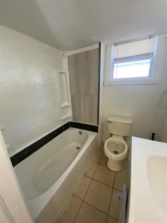 930 18th Street, Unit B Orlando, FL 32805 - Photo 10 of 11 a bathroom with a bathtub and a toilet