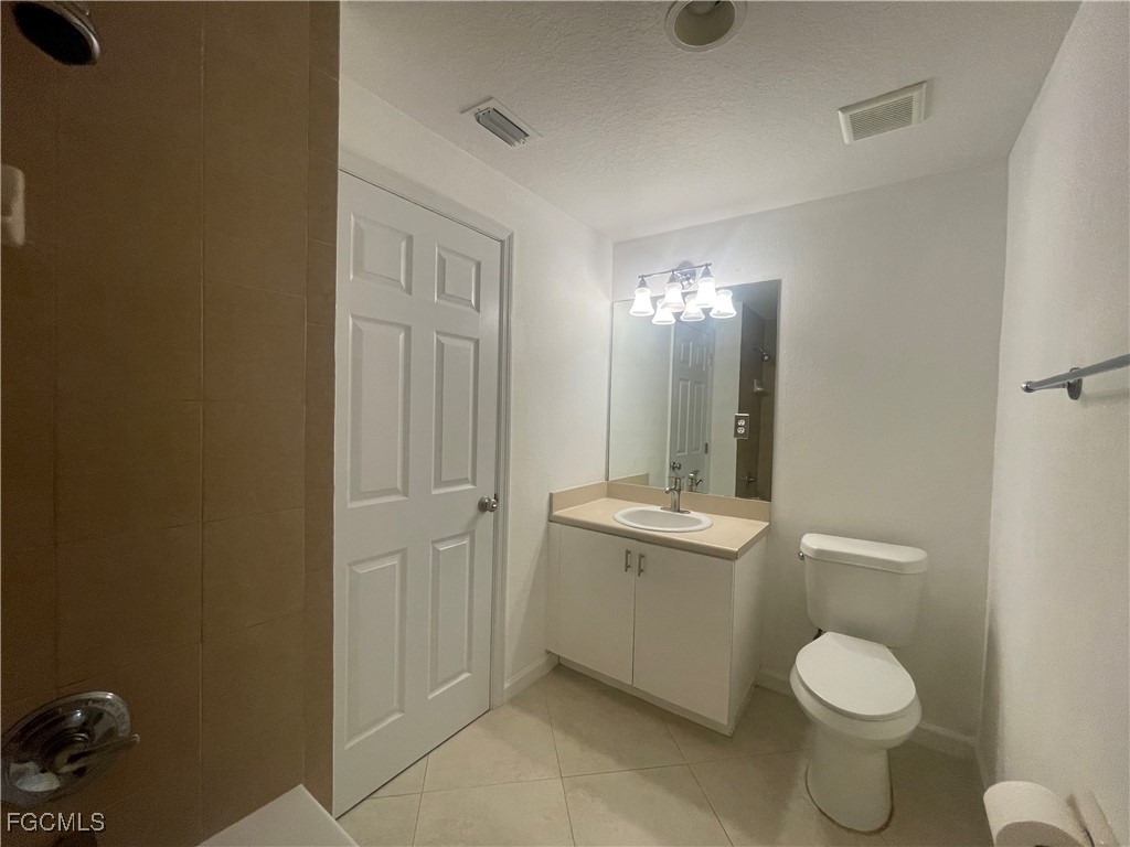 8416 Bernwood Cove Loop, Unit 1611 Fort Myers, FL 33966 - Photo 21 of 50 a bathroom with a toilet sink and mirror