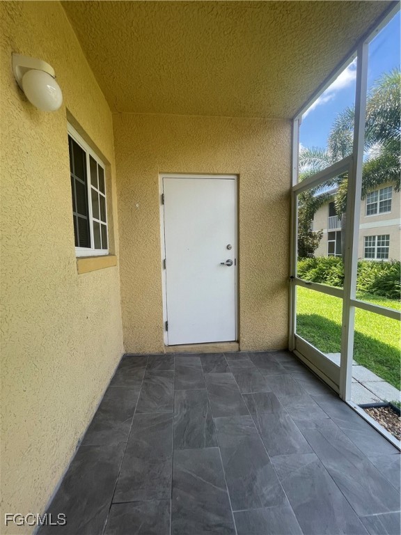 8416 Bernwood Cove Loop, Unit 1611 Fort Myers, FL 33966 - Photo 41 of 50 a view of an empty room with a balcony