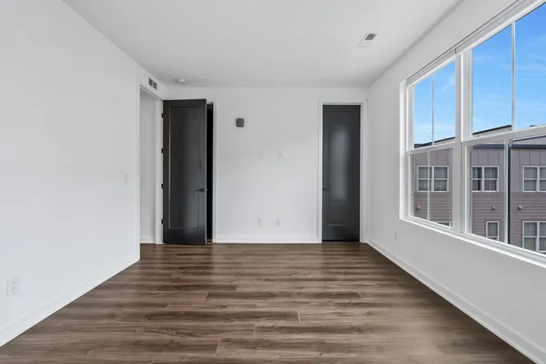 a kitchen with stainless steel appliances granite countertop a sink a stove and a wooden floor