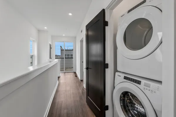 a view of empty room with wooden floor and cabinet