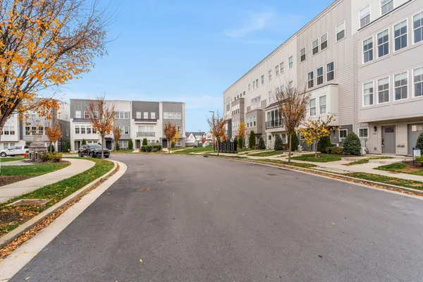 a kitchen with stainless steel appliances a sink cabinets and wooden floor
