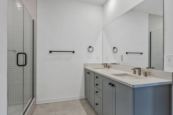 a bathroom with a sink a shower and mirror