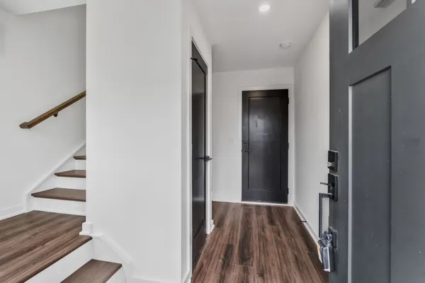 a kitchen with stainless steel appliances a stove top oven a sink and a refrigerator