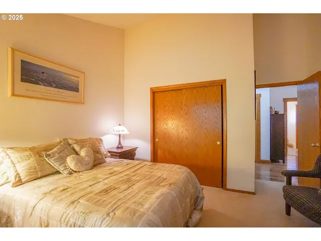 a bedroom with a bed and a painting on the wall