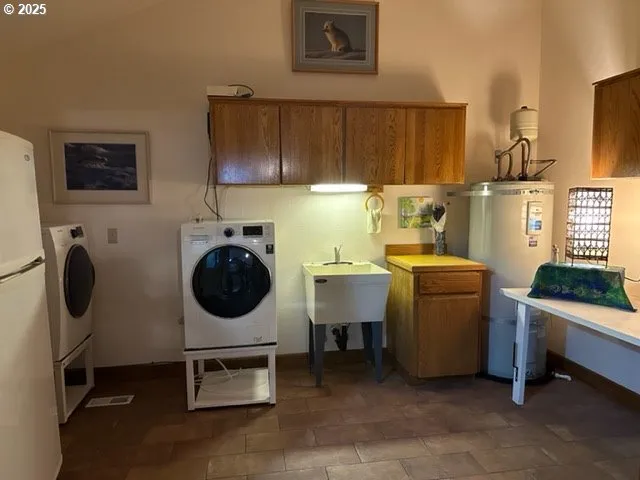 a room with a washing machine and a flat screen tv