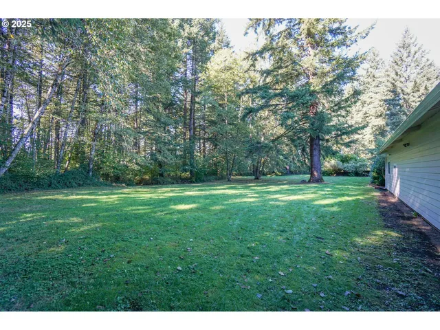 a view of outdoor space with deck and yard