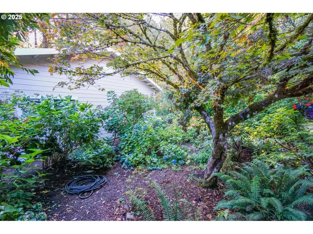 a view of a house with a yard balcony and sitting area