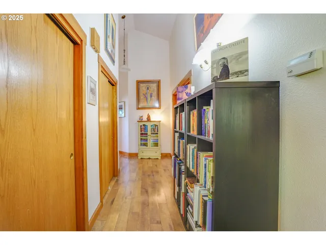 a view of entryway and hall with wooden floor
